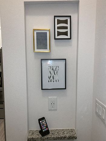 Gallery wall with framed artwork and phone charging station